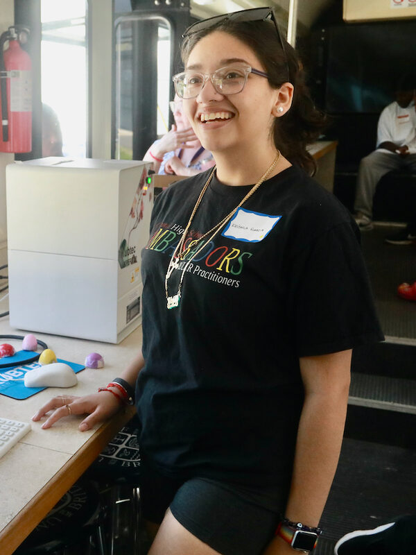A smiling young woman at a machine shop training